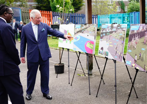 Prince Charles looking at plans for the new playground
