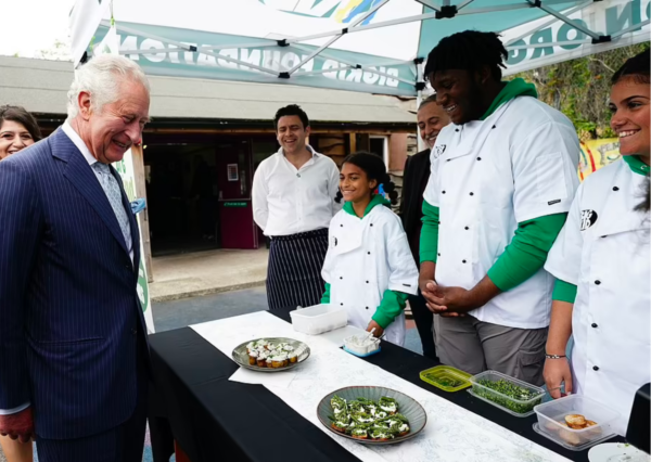 Prince Charles enjoying some canapes made by some young people at BIGKID Foundation