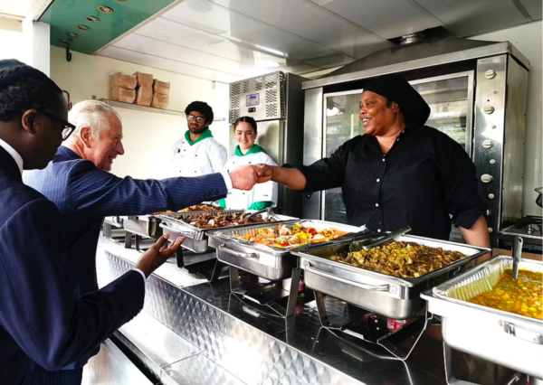 Prince Charles fist bumping a street food vendor